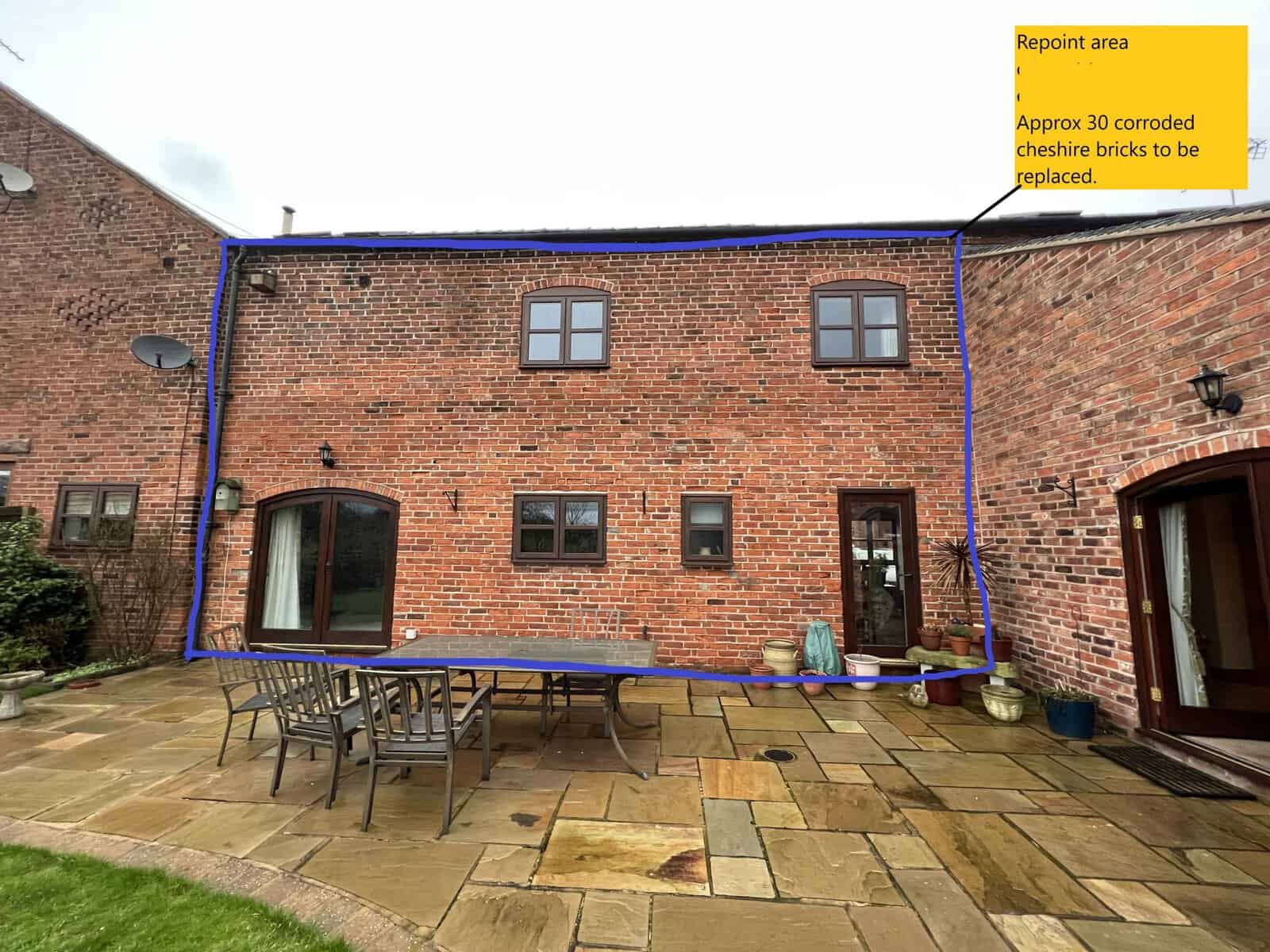 Historic brick building undergoing restoration with scaffolding in Cheshire.