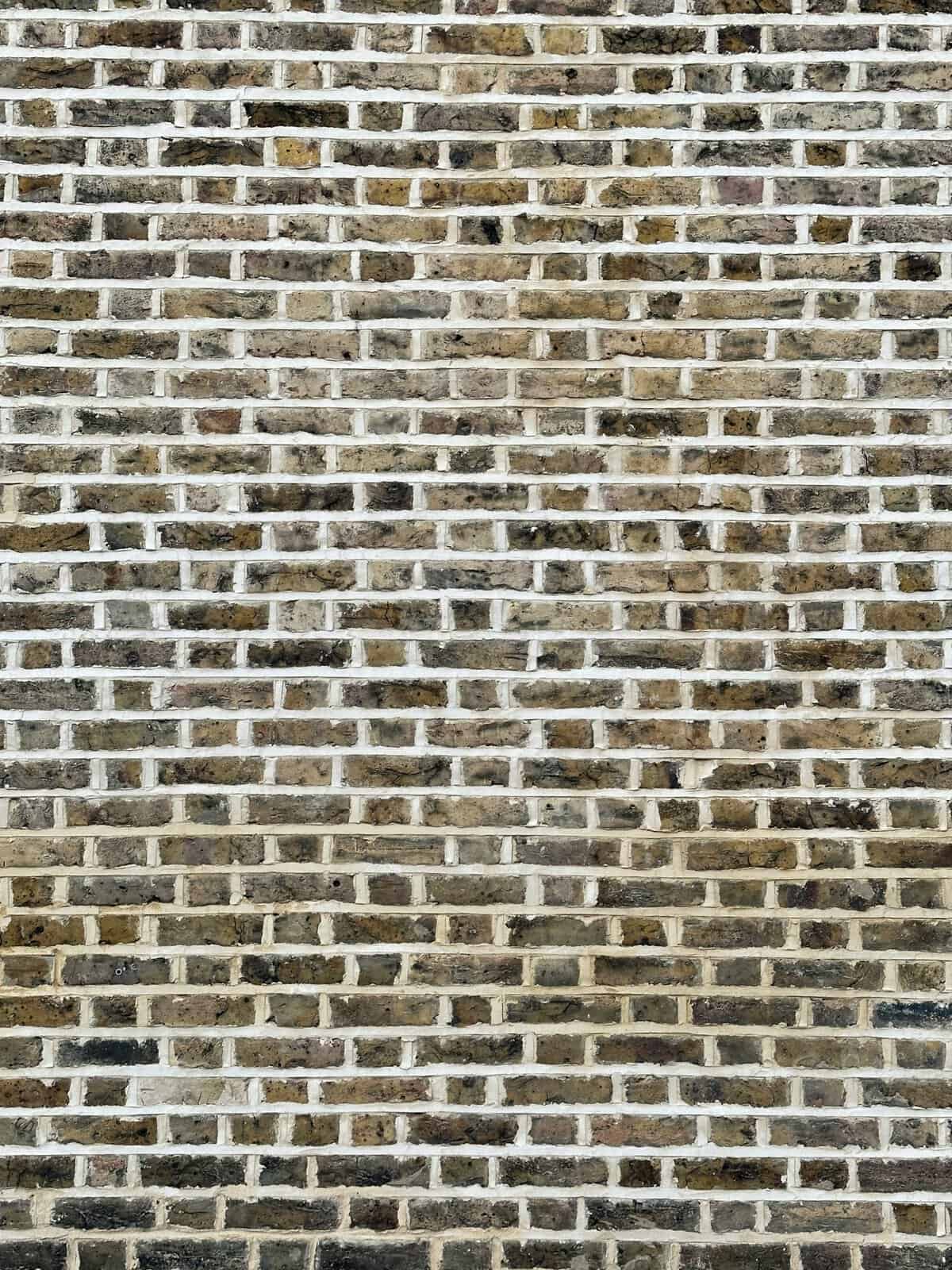 Close-up of a brick wall with weathered bricks and mortar.